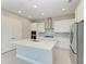 Modern kitchen with white cabinets, quartz countertops, and stainless steel appliances at 12389 Cedar Pass Trl, Parrish, FL 34219