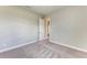 Bright bedroom with grey carpet and an adjacent bathroom at 12389 Cedar Pass Trl, Parrish, FL 34219