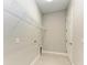 Laundry room with overhead shelving and tile floor at 12389 Cedar Pass Trl, Parrish, FL 34219