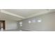 Open living room with large windows and access to other rooms at 12389 Cedar Pass Trl, Parrish, FL 34219