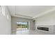 Bright living room with fireplace and sliding glass doors leading to the pool at 12389 Cedar Pass Trl, Parrish, FL 34219