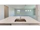 Modern kitchen island with quartz countertop and stainless steel sink at 12389 Cedar Pass Trl, Parrish, FL 34219