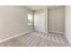 Simple bedroom with grey carpet and a large window at 12389 Cedar Pass Trl, Parrish, FL 34219