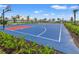 Full-size outdoor basketball court with red and blue surface at 15511 Sunny Day Dr, Lakewood Ranch, FL 34211