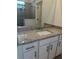 Bathroom vanity with granite countertop and white cabinets at 15511 Sunny Day Dr, Lakewood Ranch, FL 34211