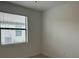 Empty bedroom with white walls and tiled floors at 15511 Sunny Day Dr, Lakewood Ranch, FL 34211