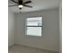 Bright bedroom with ceiling fan and window blinds at 15511 Sunny Day Dr, Lakewood Ranch, FL 34211
