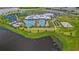 Resort-style pool with expansive sundeck and lake views at 15511 Sunny Day Dr, Lakewood Ranch, FL 34211