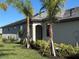 Side view of the house showing an entrance and landscaping at 15511 Sunny Day Dr, Lakewood Ranch, FL 34211