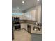Modern kitchen with white cabinets and granite counters at 15511 Sunny Day Dr, Lakewood Ranch, FL 34211