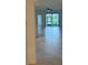 Open living area with tile floors and access to patio at 15511 Sunny Day Dr, Lakewood Ranch, FL 34211