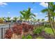Landscaped pool area with tropical plants and a fence at 15511 Sunny Day Dr, Lakewood Ranch, FL 34211
