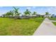 Community pool with lush landscaping and putting green at 15511 Sunny Day Dr, Lakewood Ranch, FL 34211