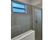 Clean shower with neutral tile and glass enclosure at 15511 Sunny Day Dr, Lakewood Ranch, FL 34211