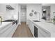 Modern kitchen with white cabinetry, island, and high-end appliances at 1591 Gulf Of Mexico Dr # 515, Longboat Key, FL 34228