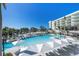Expansive resort pool with ample lounge chairs and umbrellas at 1591 Gulf Of Mexico Dr # 515, Longboat Key, FL 34228