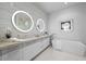 Elegant bathroom with double sinks, soaking tub, and mosaic tile at 1591 Gulf Of Mexico Dr # 515, Longboat Key, FL 34228