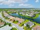 Aerial view of a suburban community with a lake, manicured lawns, and well-maintained homes at 17802 Eastbrook Ter, Lakewood Ranch, FL 34202