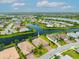 Drone shot of the home with scenic water view, lush landscaping, and tile roof at 17802 Eastbrook Ter, Lakewood Ranch, FL 34202