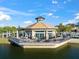 Aerial view of waterfront building, featuring scenic lake views and an inviting outdoor patio at 17802 Eastbrook Ter, Lakewood Ranch, FL 34202