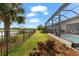 Fenced backyard featuring a pool, lush landscaping, and water view beyond the metal fence at 17802 Eastbrook Ter, Lakewood Ranch, FL 34202