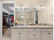 A double-sink bathroom vanity with granite counters, a view of the walk-in closet at 17802 Eastbrook Ter, Lakewood Ranch, FL 34202