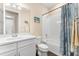 Neat bathroom with single sink vanity, framed mirror, and tub with shower at 17802 Eastbrook Ter, Lakewood Ranch, FL 34202