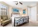 Comfortable bedroom featuring a decorative iron bed frame and coastal-themed decor at 17802 Eastbrook Ter, Lakewood Ranch, FL 34202