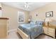 Cozy bedroom with a ceiling fan, plantation shutters, and dual nightstands at 17802 Eastbrook Ter, Lakewood Ranch, FL 34202
