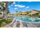 Resort-style pool features lounge chairs, tables, and mature landscaping; blue skies are reflected in the calm water at 17802 Eastbrook Ter, Lakewood Ranch, FL 34202