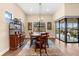 Elegant dining room with wood floors, area rug, and modern lighting fixture at 17802 Eastbrook Ter, Lakewood Ranch, FL 34202