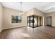 Open-concept dining area with hardwood floors, chandelier lighting, and sliding door access to backyard at 17802 Eastbrook Ter, Lakewood Ranch, FL 34202