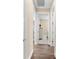 Bright hallway with hardwood floors leading to bedrooms at 17802 Eastbrook Ter, Lakewood Ranch, FL 34202