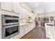 Bright kitchen with stainless steel appliances, white cabinets, and a separate dining area at 17802 Eastbrook Ter, Lakewood Ranch, FL 34202