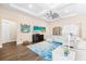 Bright living room with a large sectional sofa, wood floors, decorative ceiling fan and coastal decor at 17802 Eastbrook Ter, Lakewood Ranch, FL 34202