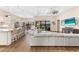 Open concept living room featuring hardwood floors, white sofa, and a view of the pool at 17802 Eastbrook Ter, Lakewood Ranch, FL 34202