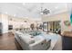 Expansive open-concept living space featuring hardwood flooring, modern furnishings, and pool views at 17802 Eastbrook Ter, Lakewood Ranch, FL 34202