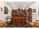 Spacious office with custom built-in shelving and a large wooden desk at 17802 Eastbrook Ter, Lakewood Ranch, FL 34202