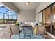 Relaxing covered patio with plush seating, gas fireplace, outdoor kitchen and screened in pool at 17802 Eastbrook Ter, Lakewood Ranch, FL 34202