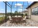 Screened patio with brick flooring and outdoor dining set, perfect for entertaining guests at 17802 Eastbrook Ter, Lakewood Ranch, FL 34202