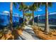 Tree lined walkway with shade in between fenced community tennis courts for a pleasant environment at 17802 Eastbrook Ter, Lakewood Ranch, FL 34202