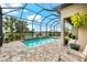 Screened pool and patio area with brick pavers, water feature, and lush landscaping at 17802 Eastbrook Ter, Lakewood Ranch, FL 34202