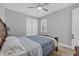 Neutral bedroom with a ceiling fan, closet, and a charming wood frame queen-sized bed at 17890 Cherished Loop, Bradenton, FL 34211