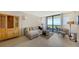 Bright living room with water view, featuring comfortable seating and hardwood floors at 1930 Harbourside Dr # 145, Longboat Key, FL 34228