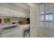 Bright laundry room, featuring washer, dryer, and storage cabinets at 1930 Harbourside Dr # 145, Longboat Key, FL 34228