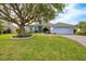 One-story home with gray exterior, landscaping, and a two-car garage at 3226 44Th E Dr, Bradenton, FL 34203