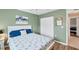 Bedroom with queen bed, light green walls, and double doors to another room at 3226 44Th E Dr, Bradenton, FL 34203