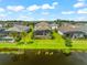 Aerial view of houses with private pools and lush green lawns, located by a lake at 4704 Foxtail Dr, Parrish, FL 34219