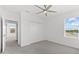 Bedroom with gray carpet, ceiling fan, walk-in closet and water view at 4704 Foxtail Dr, Parrish, FL 34219