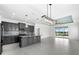 Modern kitchen with island, opens to Gathering room with pool view at 4704 Foxtail Dr, Parrish, FL 34219